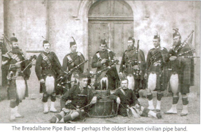 Duncan Campbell, left as Pipe Sergeant of the Breadalbane Pipe Band. At far right is Duncan MacDougall, Pipe Major. Photograph was likely taken in the 1880s.