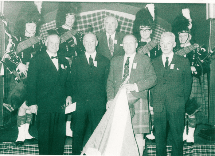 This 1974 collection of Shotts and Dykehead notables includes, back row, Pipe Major Thomas MacAllister Jnr, left, with Ian P. Duncan beside him. Pipe Sergeant John Barclay is on the right. The kilted man in the front is band president Duncan MacLean, the subject of a fine Tom Muirhead 6/8 march.